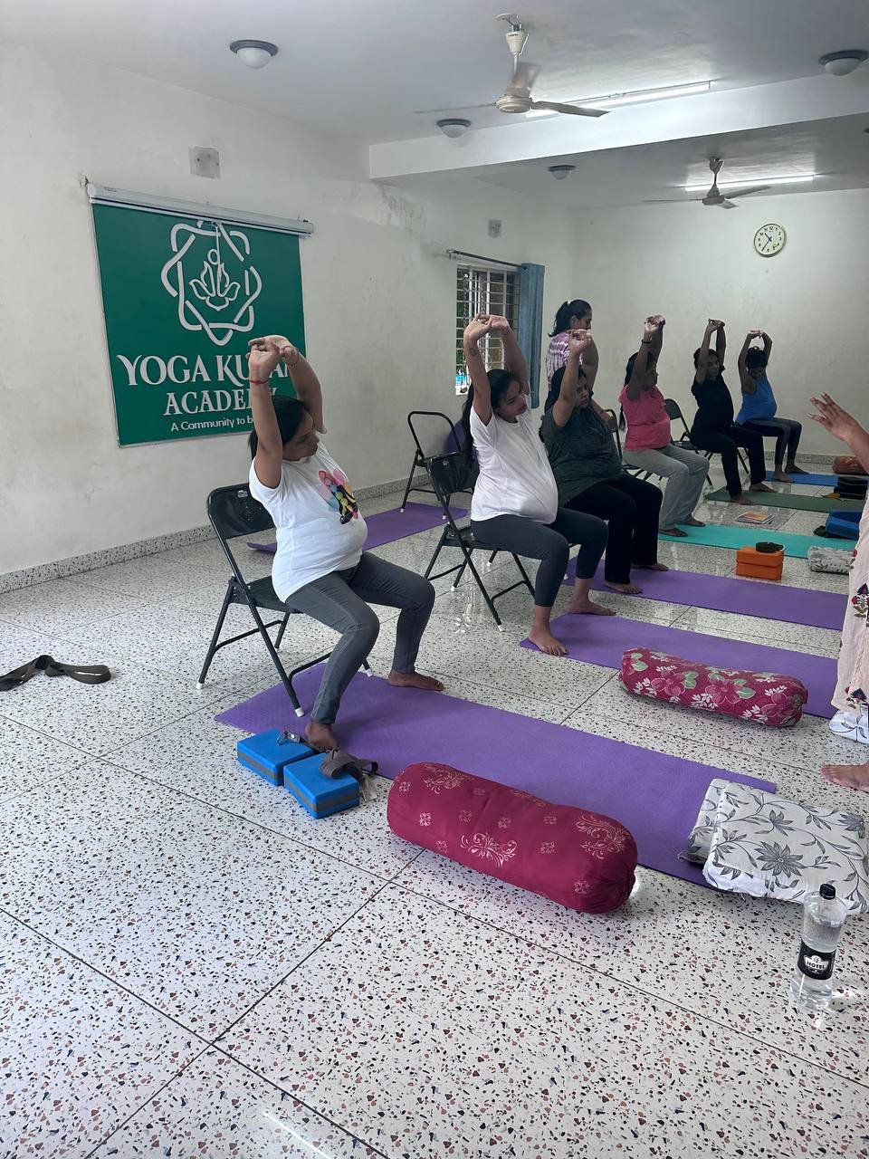 Students practicing yoga at Yogakulam Academy