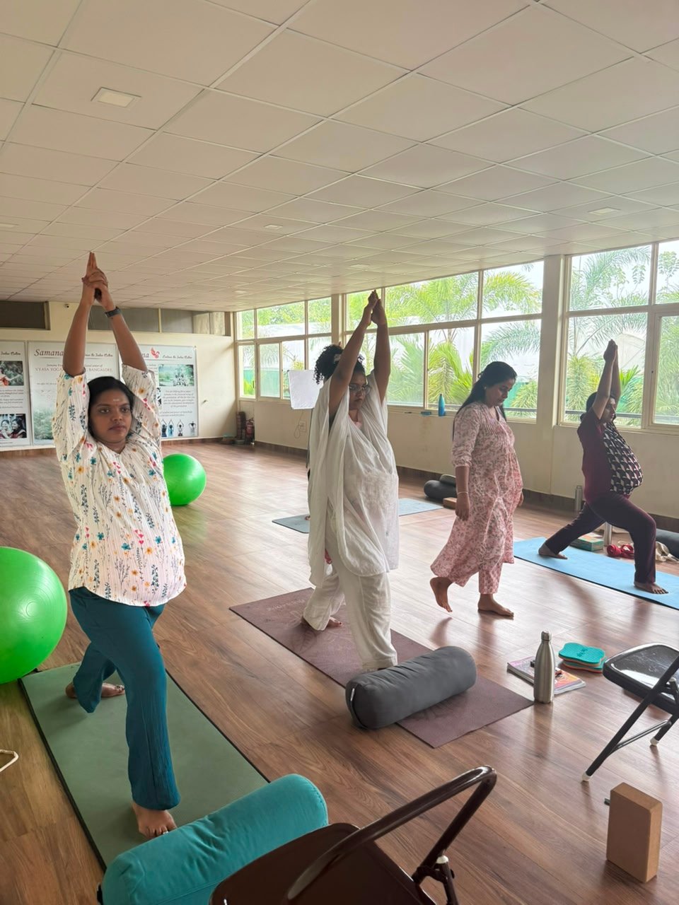 Students practicing yoga at Yogakulam Academy