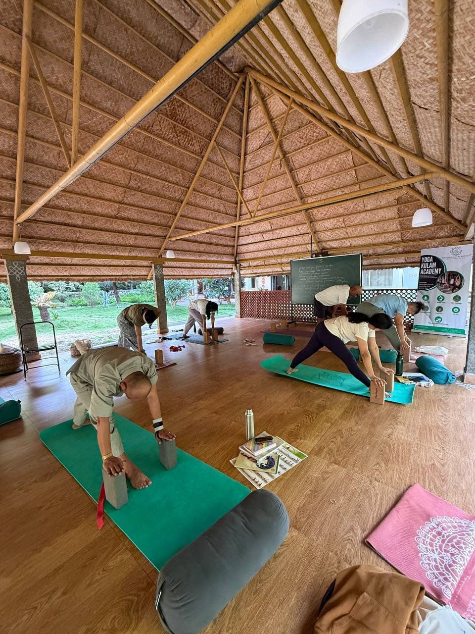Students practicing yoga at Yogakulam Academy